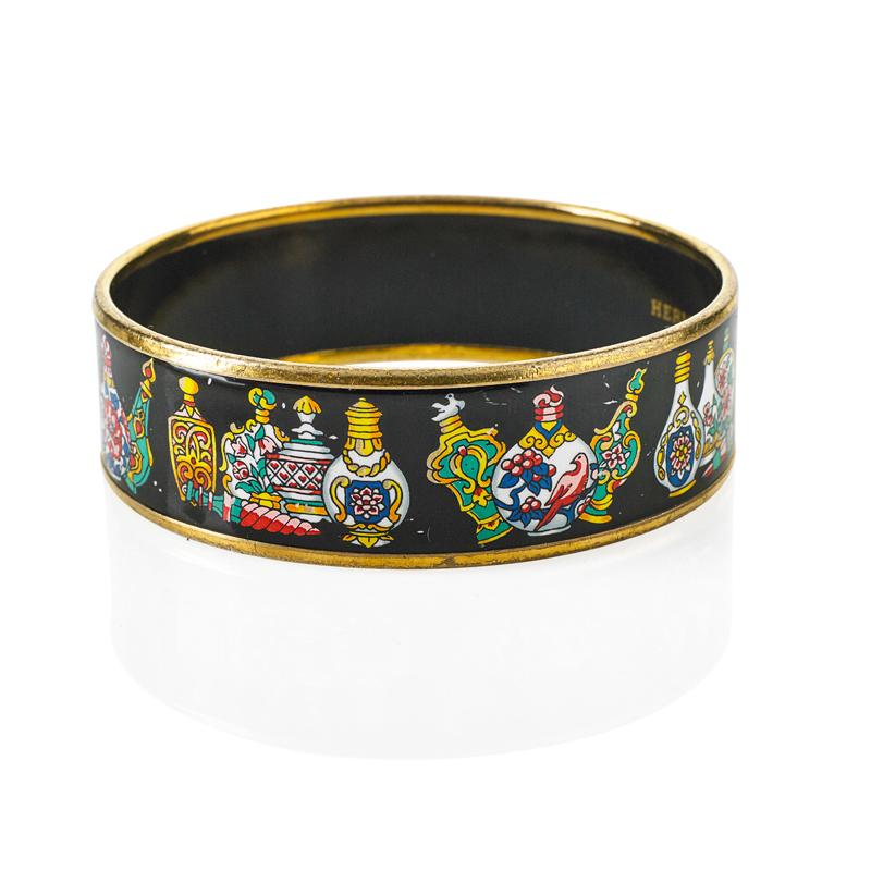 Appraisal: HERMES ENAMELED CUFF WITH PERFUME BOTTLE MOTIF Polychrome bottles on