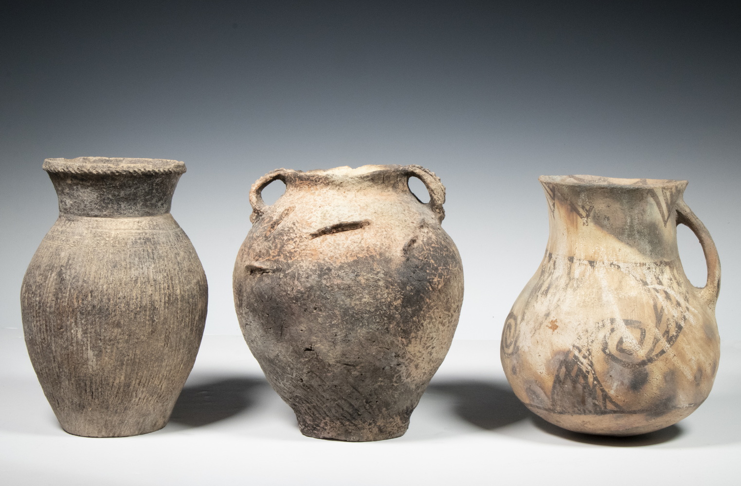 Appraisal: CHINESE NEOLITHIC POTTERY VESSELS Including Single handle round bottomed jug