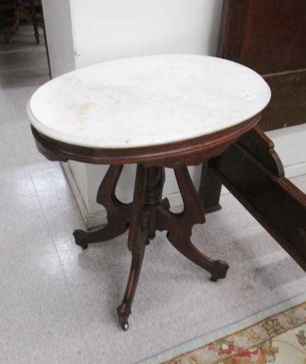 Appraisal: VICTORIAN MARBLE-TOP WALNUT LAMP TABLE American last quarter of the