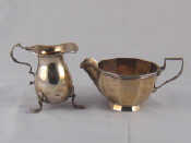 Appraisal: A silver cream jug of baluster form on shell-capped feet