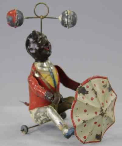 Appraisal: MAN TWIRLING BALLS AND UMBRELLA Gunthermann Germany hand painted tin