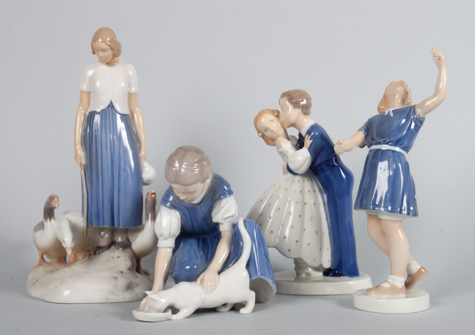 Appraisal: Four Bing Grondahl porcelain groups including girl feeding cat kissing