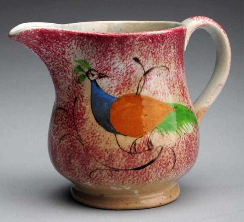 Appraisal: th Century Red Spatterware Creamer Original peafowl decoration Some light