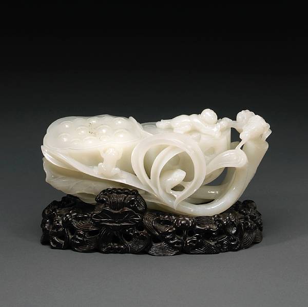 Appraisal: A good white jade carving of a lotus plant Featuring