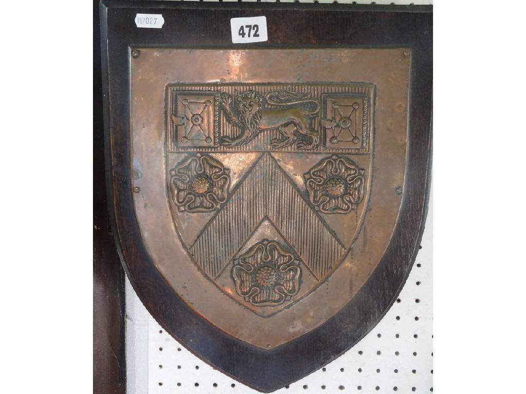 Appraisal: A copper Heraldic shield shaped coat of arms with a