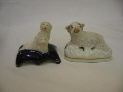 Appraisal: A STAFFORDSHIRE PORCELAIN RAM modelled recumbent wide and a model