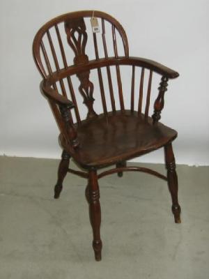 Appraisal: A YEW WOOD WINDSOR ARMCHAIR of low double hoop form