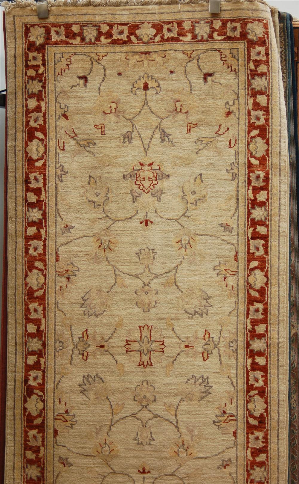 Appraisal: HANDMADE VEGETABLE DYED RUNNER having an ivory field slim rust