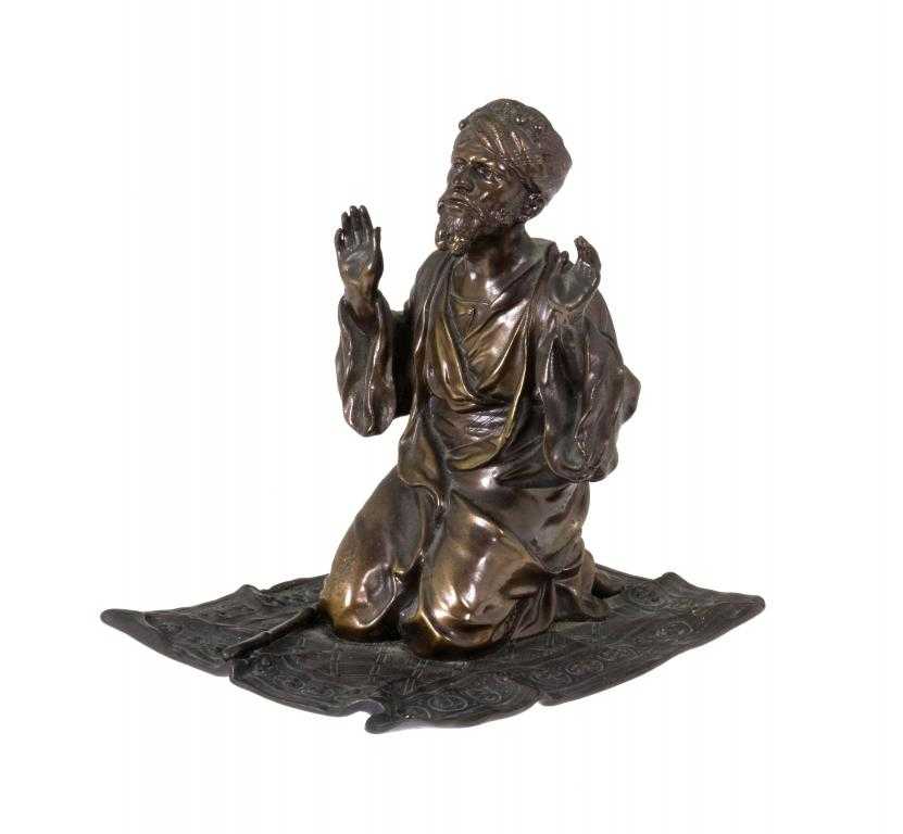 Appraisal: AN AUSTRIAN PATINATED BRONZE STATUETTE OF A MAN AT PRAYER