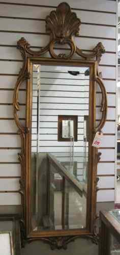 Appraisal: A DECORATOR'S BEVELED WALL MIRROR having shell crest accented with