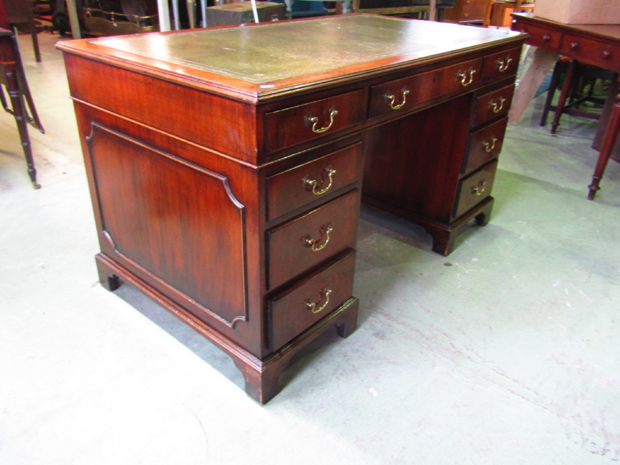 Appraisal: A reproduction mahogany knee-hole twin pedestal writing desk in the