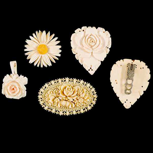 Appraisal: Carved Ivory Grouping A grouping of two brooches a pendant