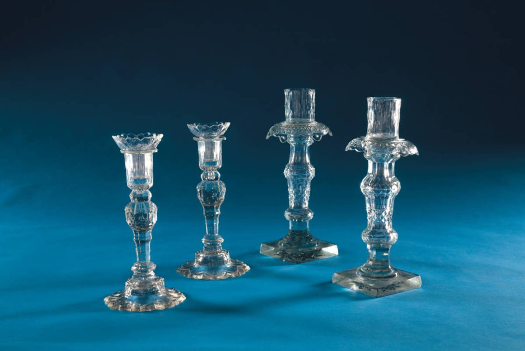 Appraisal: TWO PAIR OF ANGLO-IRISH CUT GLASS CANDLESTICKS EACH WITH DETACHABLE