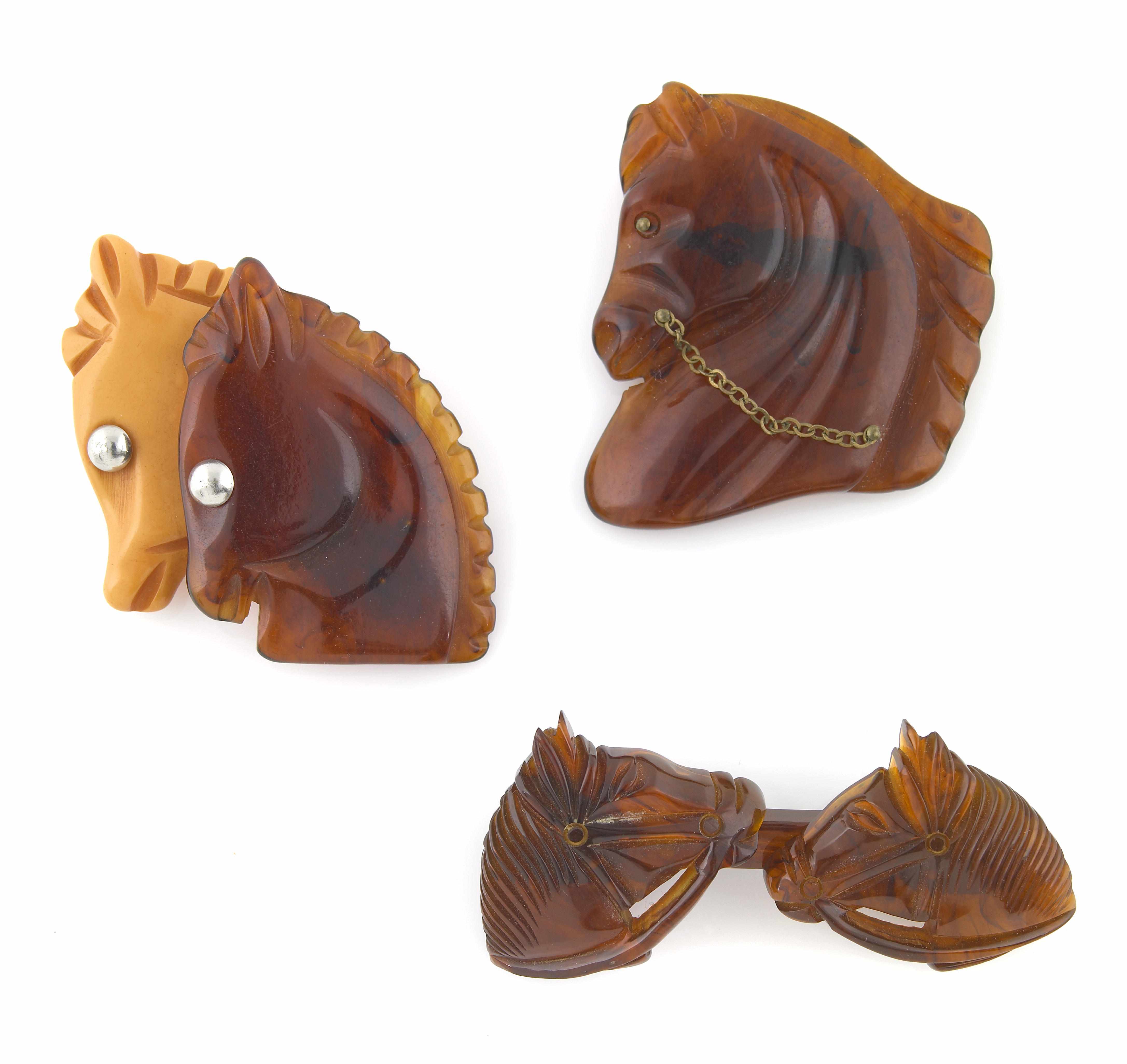 Appraisal: Three rootbeer Bakelite horse brooches one with butterscotch dimensions x