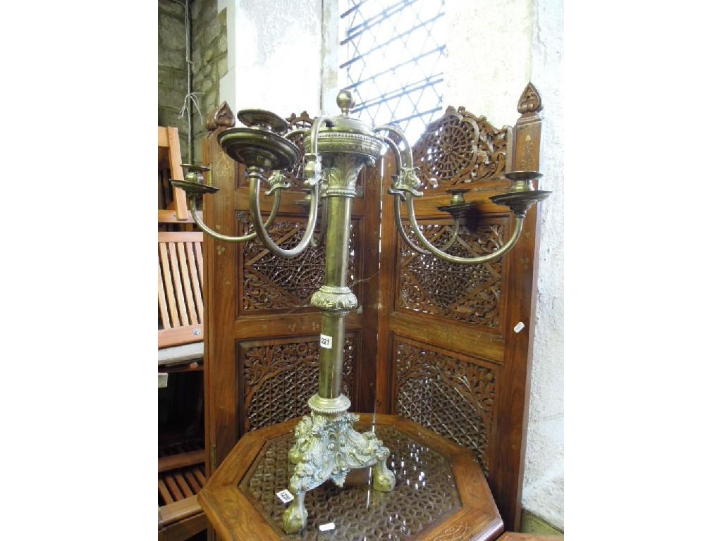 Appraisal: A brass five branch candelabra raised on a central turned