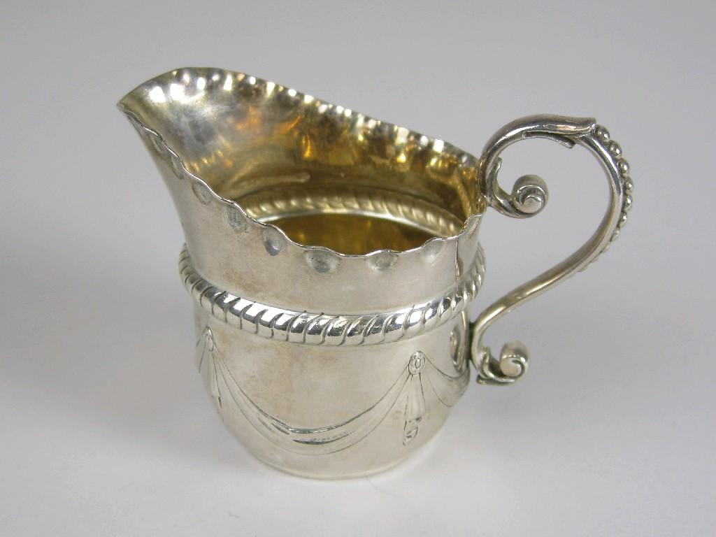 Appraisal: A Victorian small Cream Jug with swag embossing beaded scroll