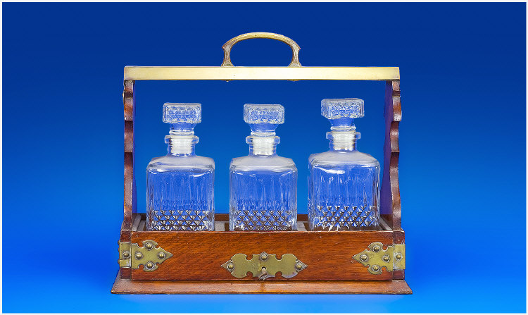 Appraisal: Oak Cased Tantalus Containing Three Decanters Brass Straps Mounts And