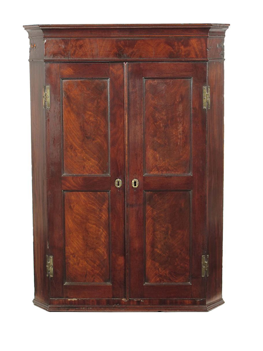 Appraisal: A late George III mahogany hanging corner cupboard