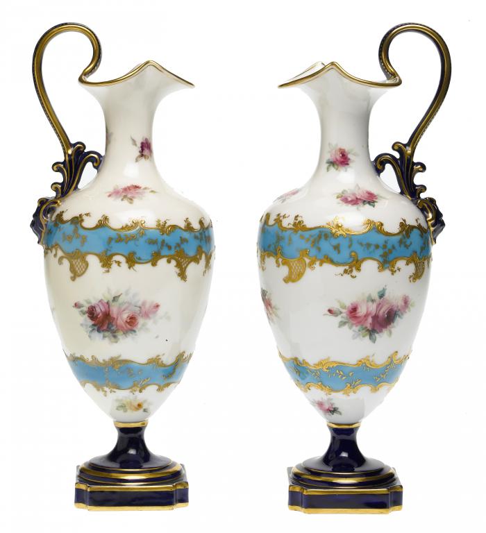 Appraisal: A PAIR OF ROYAL WORCESTER SHIELD SHAPED EWERS painted with