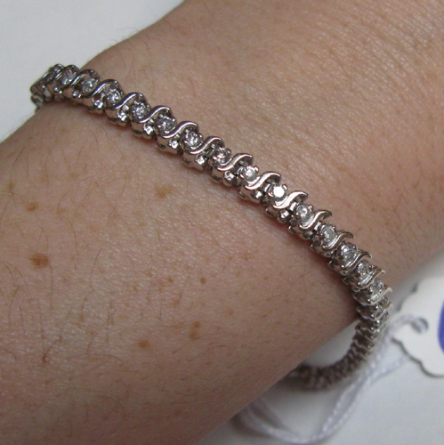 Appraisal: DIAMOND AND FOURTEEN KARAT WHITE GOLD BRACELET set with round-cut