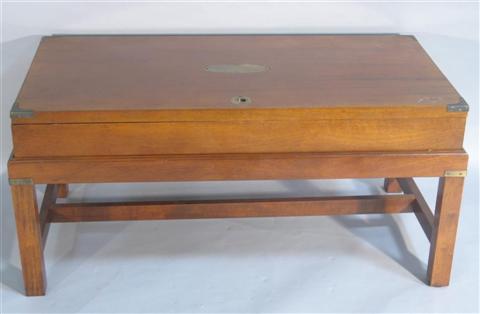 Appraisal: CAMPAIGN STYLE BOX TOP COFFEE TABLE th century the rectangular