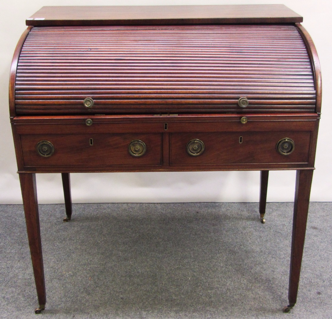 Appraisal: A George III mahogany writing desk the retractable tambour top