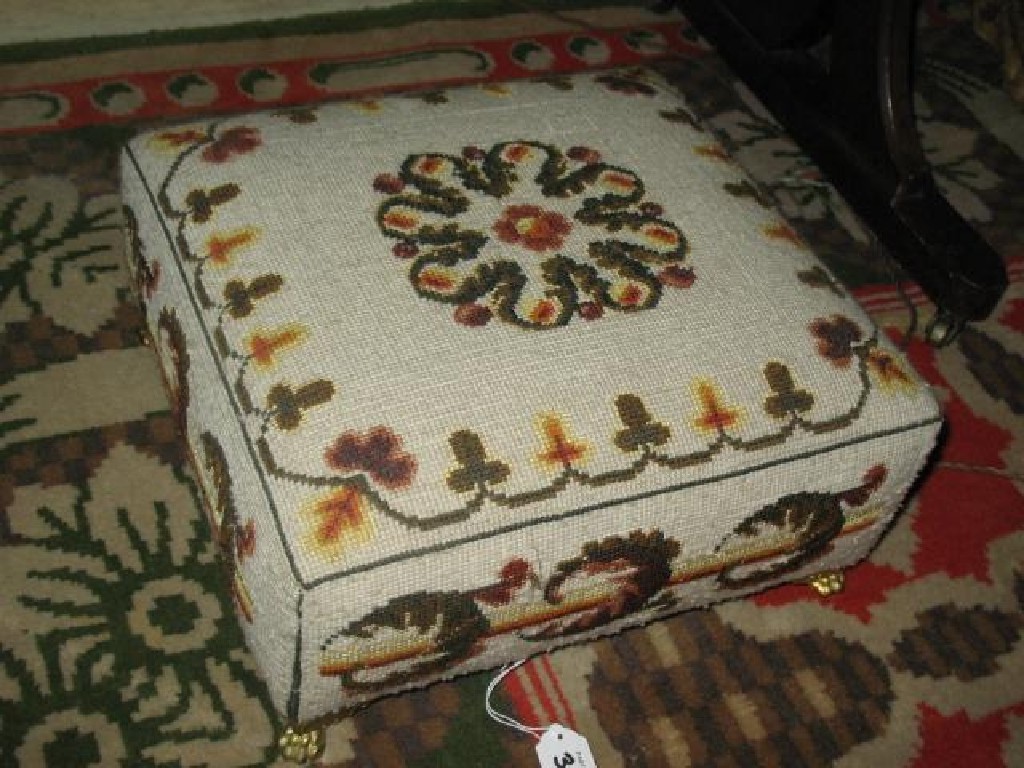 Appraisal: A VICTORIAN STYLE FOOTSTOOL with four bun feet wide a