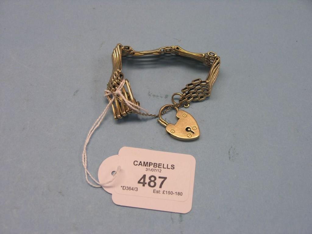 Appraisal: A ct gold gate-link bracelet with heart-shape padlock pendant grams