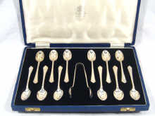 Appraisal: A boxed set of twelve silver tea spoons with tongs