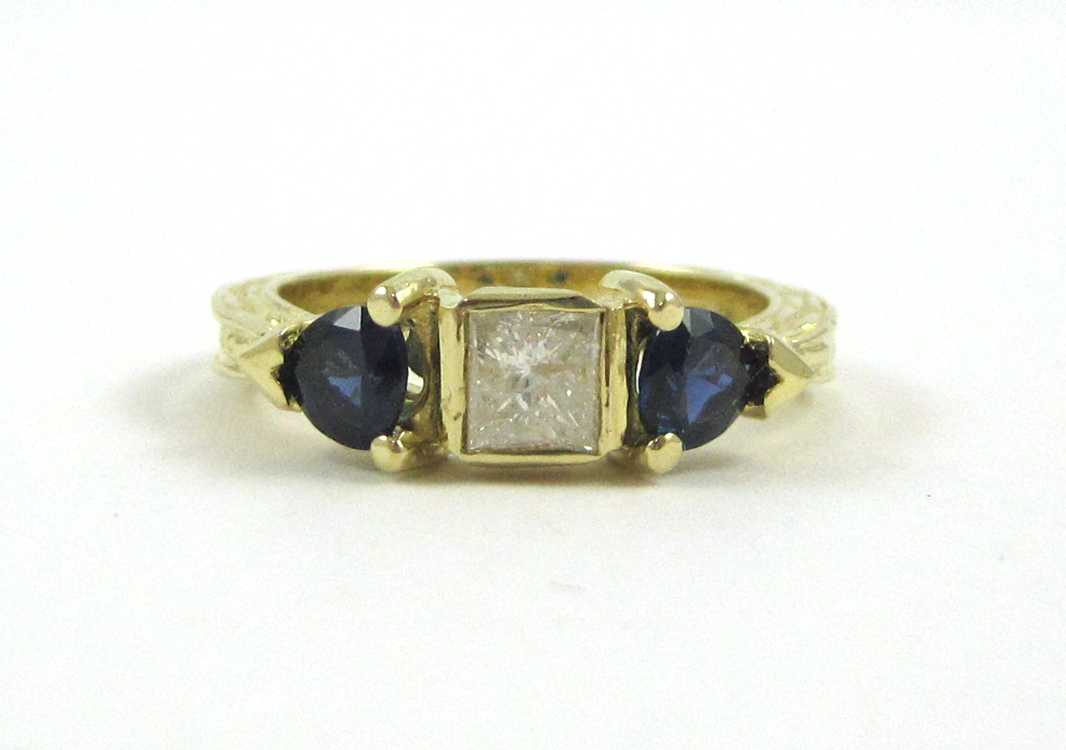 Appraisal: DIAMOND SAPPHIRE AND FOURTEEN KARAT GOLD RING with two trillion-cut