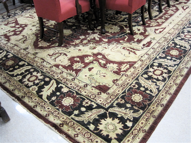 Appraisal: HAND KNOTTED ORIENTAL CARPET Pakistani Heriz central geometric medallion and