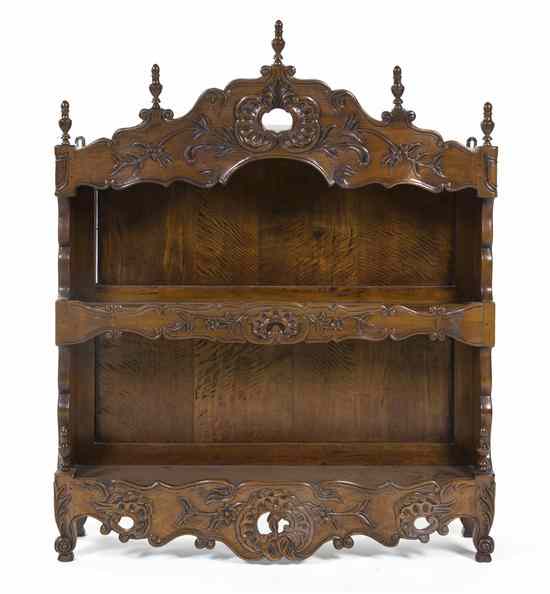 Appraisal: A Victorian Walnut Whatnot Shelf having a carved valence over