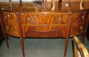 Appraisal: A mahogany bowfront sideboard th century with two central drawers