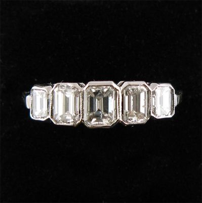 Appraisal: A diamond five stone ring the graduated emerald cut diamonds