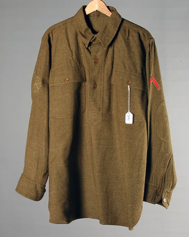 Appraisal: Wool shirt with infantry insignia and honorable discharge chevron