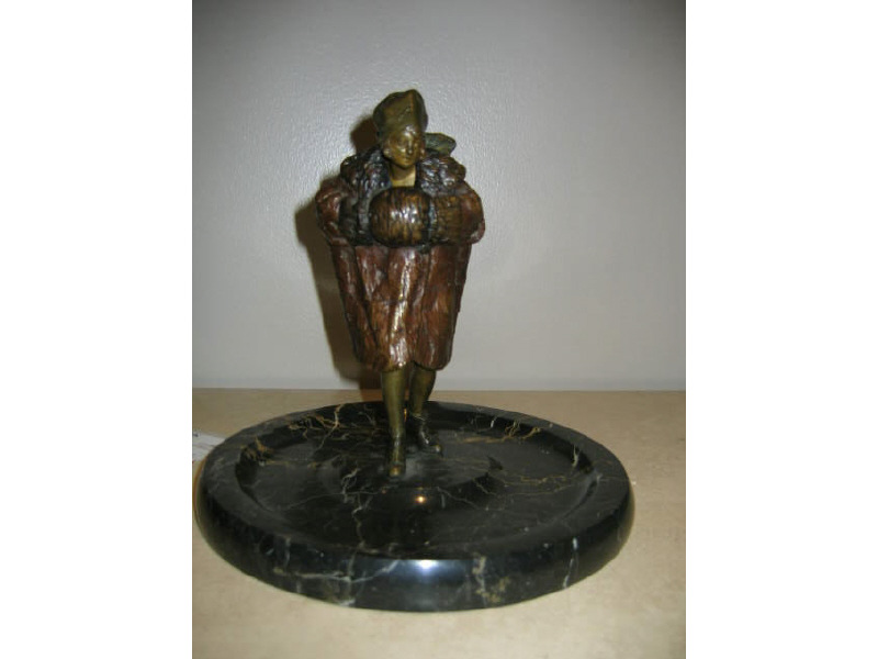 Appraisal: AUSTRIAN PATINATED BRONZE FIGURE Depicting a woman wearing a fur