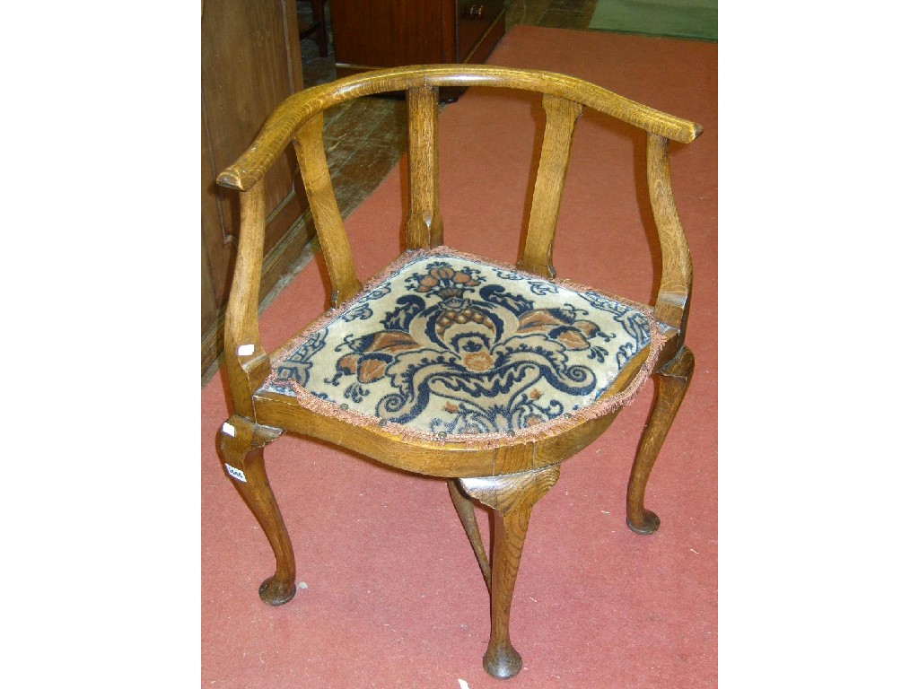 Appraisal: A set of four Edwardian oak corner chairs with shaped