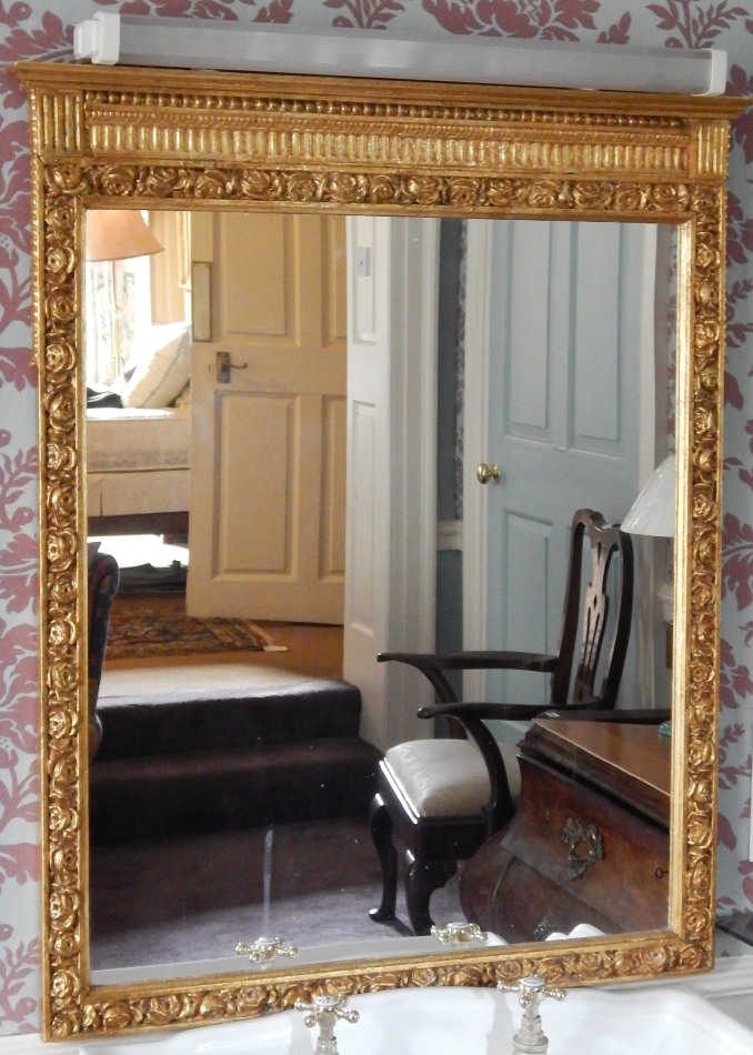 Appraisal: A gilt gesso wall mirror the frame decorated with flowers