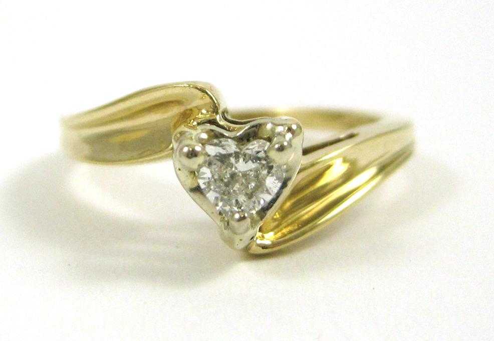 Appraisal: DIAMOND AND FOURTEEN KARAT GOLD SOLITAIRE RING set with a