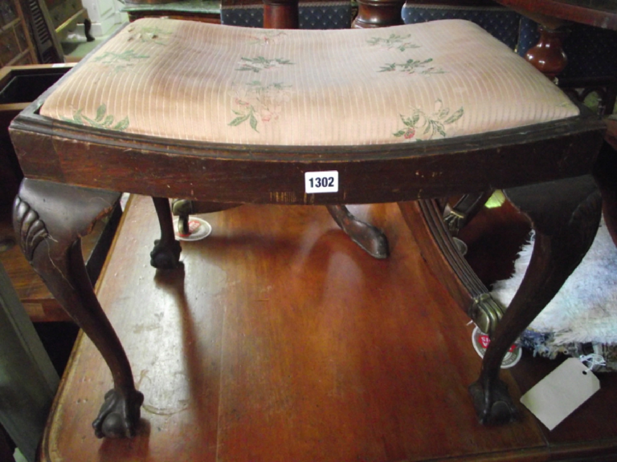 Appraisal: An Edwardian upholstered dressing stool with dished top on claw