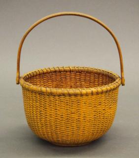 Appraisal: Nantucket basket A Nantucket woven basket Painted golden yellow with