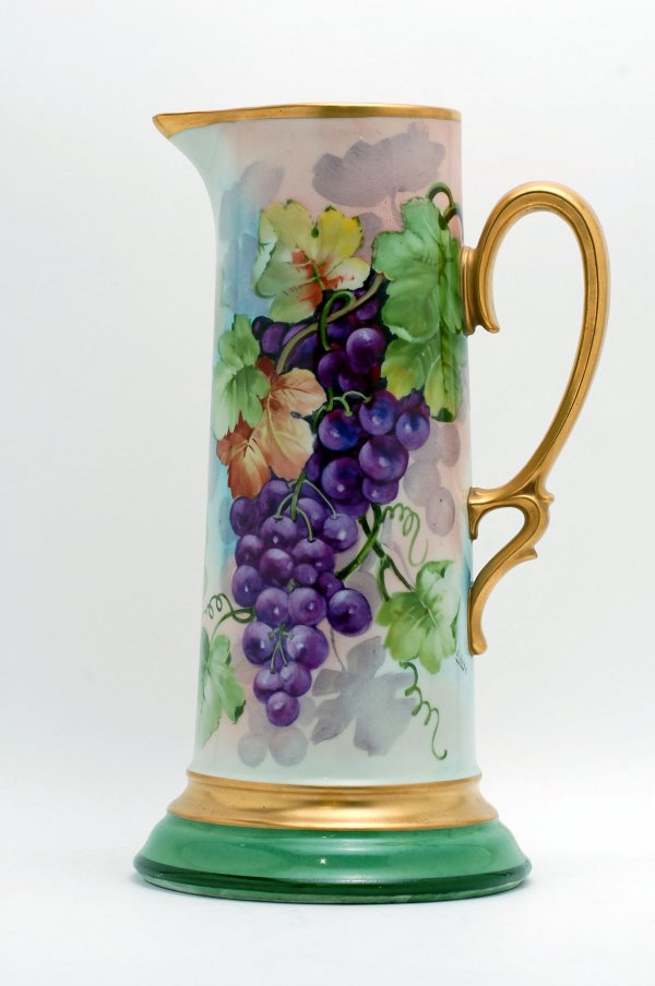 Appraisal: Handpainted Austrian porcelain pitcher cylindrical in shape on stepped green