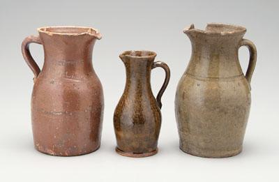 Appraisal: Three stoneware pitchers one with brown glaze marked on side