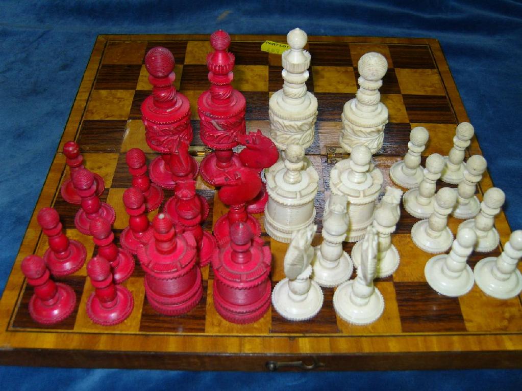 Appraisal: A mahogany box containing a set of stained bone chess