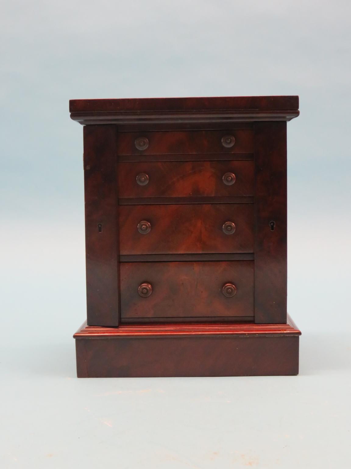 Appraisal: A Victorian miniature mahogany Wellington chest four drawers with flame-veneered