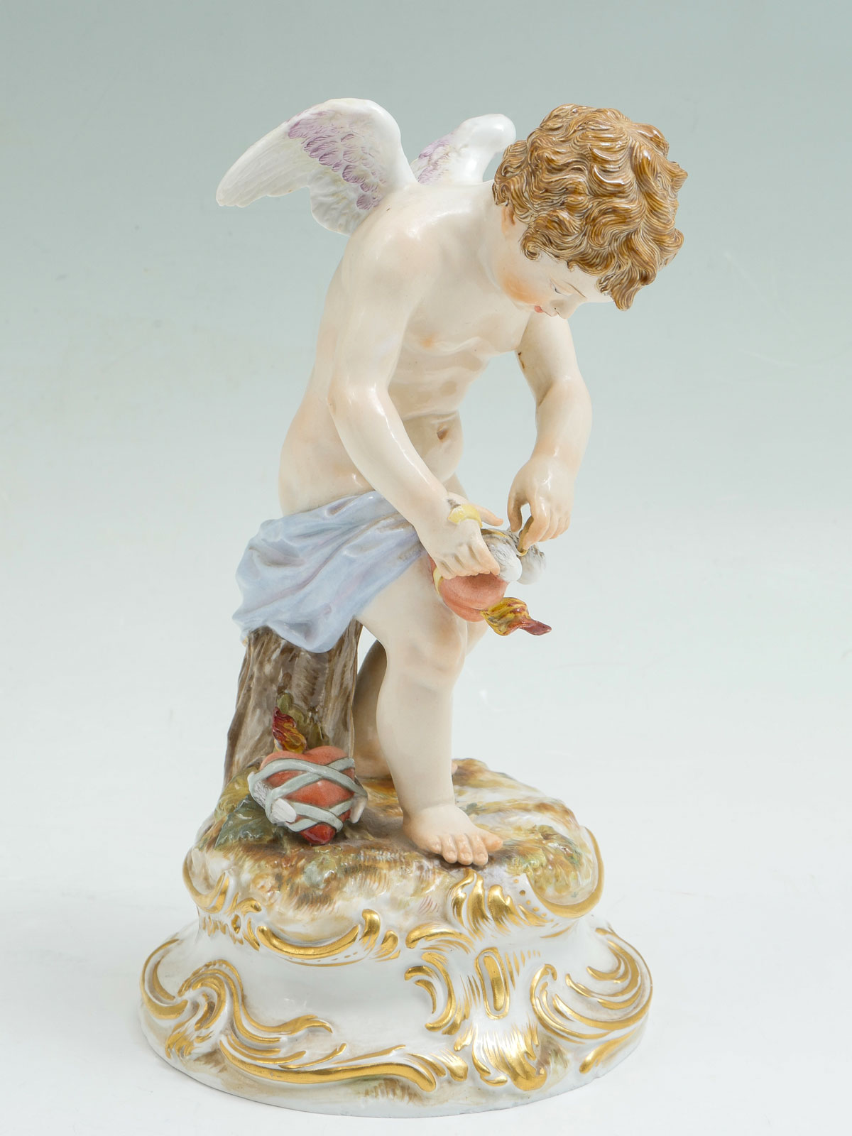 Appraisal: MEISSEN PORCELAIN CUPID BINDING HEART Mischievous cherub binding flying hearts