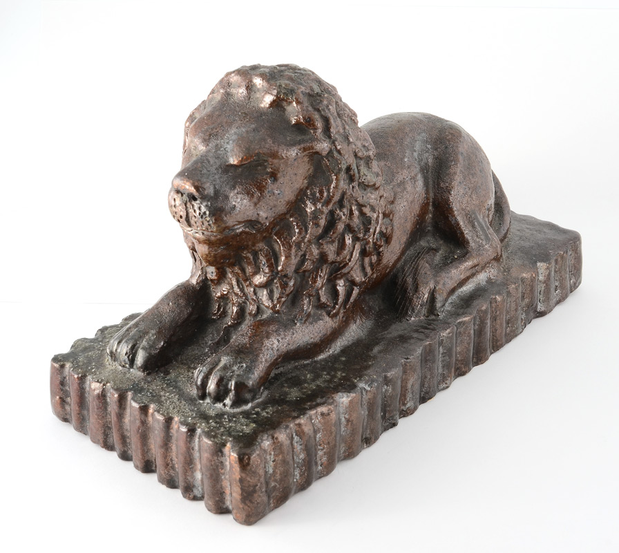 Appraisal: FOLK ART SEWER TILE RECLINING LION Brown glaze marked on