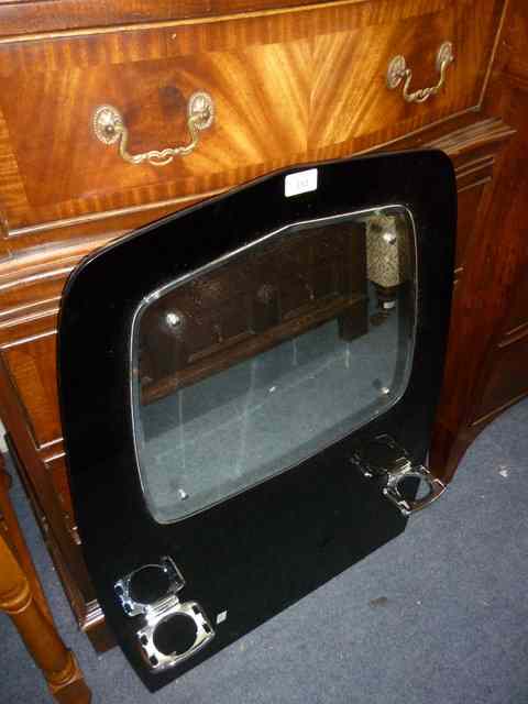 Appraisal: A 'S BLACK OPAQUE AND MIRRORED GLASS SPLASH BACK mounted