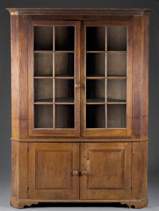 Appraisal: Large American walnut corner cabinet Glass double top doors and