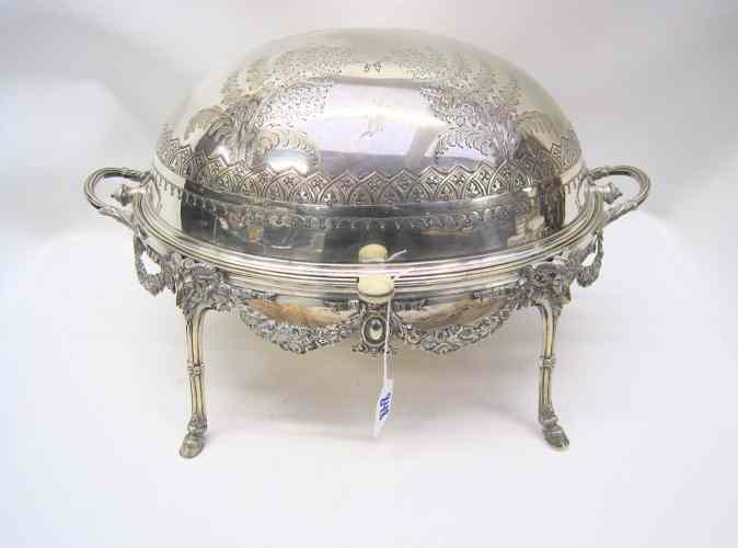 Appraisal: AN ENGLISH VICTORIAN SILVER-PLATED REVOLVING BREAKFAST DISH Chased and engraved